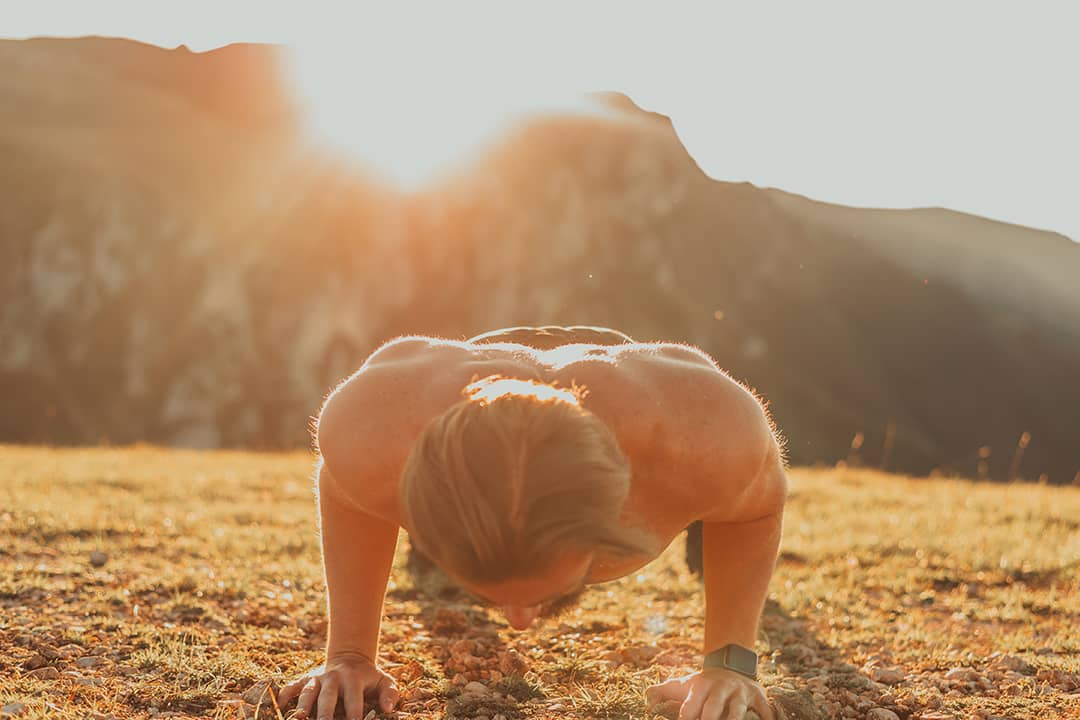 An athlete doing push-up exercises early in the morning.